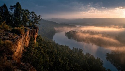 Misty river valley at sunrise from a high vantage point