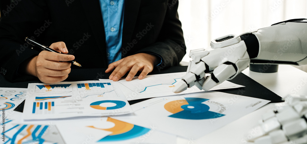 Poster a business professional assesses financial data while a robotic hand extends towards documents, high