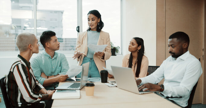 Business people, meeting and document with laptop for task, delegation or brainstorming at office. Group of employees, strategy discussion and technology with paperwork for project management or idea