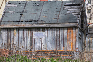 An old abandoned wooden barn on a summer day