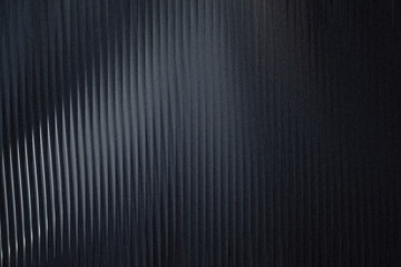 Obraz premium A dark, textured background with vertical ribbed patterns and a subtle gradient, creating a sophisticated and modern aesthetic