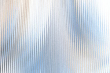 A textured background with vertical ribbed lines, shimmering with soft light and subtle color gradients of blue and beige