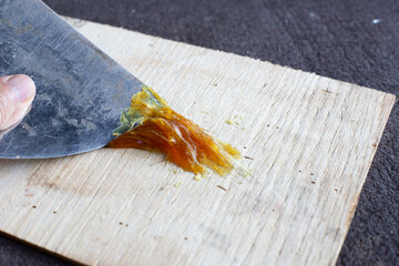 Workers applying rubber glue to the wood floor	