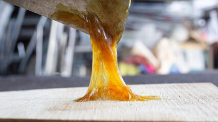 Workers applying rubber glue to the wood floor	