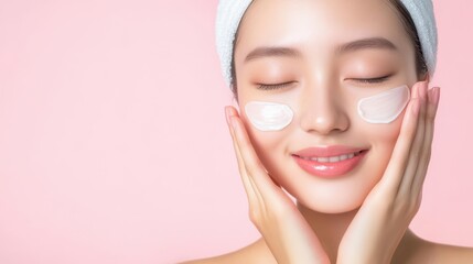 A young woman enjoys a skincare routine, applying cream with her eyes closed.