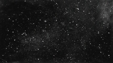 Fototapeta premium Grainy black and white image of a star field. Numerous scattered specks of light against a dark backdrop convey celestial vastness