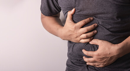 healthcare and health problem concept , man with stomach pain on white background. unhappy man...