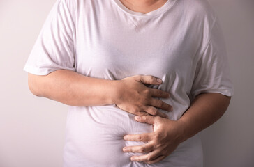 fat woman with stomach pain on white background