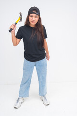 Tough young boyish woman holding a hammer up near her shoulder with a fierce look. Isolated on a...