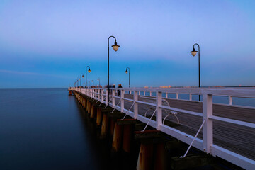 Sunset sky and beautiful old pier on the Baltic Sea in Gdynia, Poland