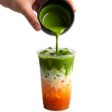 Hand pouring vibrant green matcha tea into layered iced drink isolated on transparent background