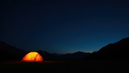 Illuminated orange tent stands out against a backdrop of dark mountains and a star-studded night sky.