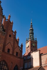 Fototapeta premium Historic architecture and bell tower under clear blue sky in Gdansk during daylight hours