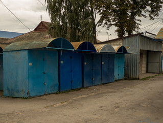 A number of blue portable trading boutiques sitting next to each other