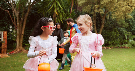 Candy, halloween and walking with girls outdoor together for celebration, fantasy or holiday....