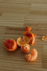overhead view of peeled mandarin oranges on butcher block counter