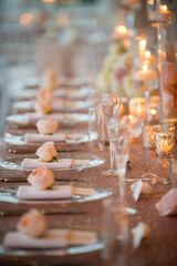 Romantic Wedding Table Setting with Roses and Candlelight Glow