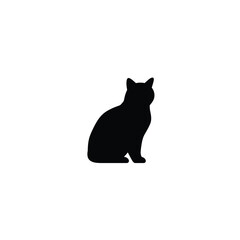 A black cat sitting in profile looking to the right side
