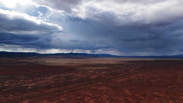 Drone view of storm clouds forming over red outback plains in South Australia