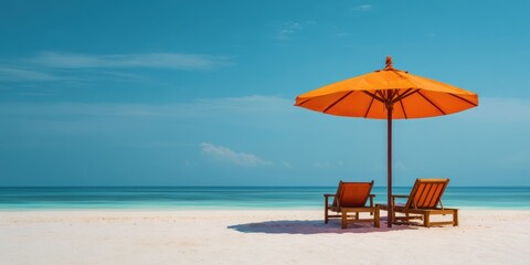 Fototapeta premium The Umbrella and Two Beach Chairs on Tropical White Sand Shoreline