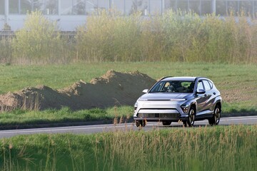Driver in electric car cruising open space