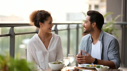 Balcony setting with a couple enjoying a romantic evening during soft lighting representing love, romance, intimacy, connection, warmth, togetherness - Powered by Adobe