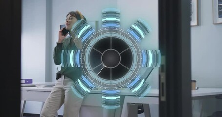 Businesswoman leaning on desk calling client and activating rotating hologram processing insights - Powered by Adobe