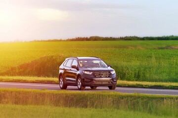 Fototapeta premium Driving a 4x4 SUV through green nature