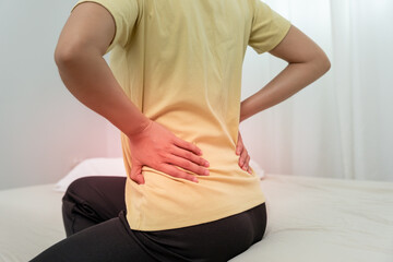 woman holding lower back while and suffer from unbearable pain health and problems, chronic back...