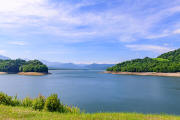 Obraz premium Nukabira River Bridge with Nukabira Lake, River and Dam under July Blue Sky, Hokkaido Japan