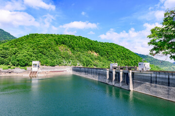 Nukabira River Bridge with Nukabira Lake, River and Dam under July Blue Sky, Hokkaido Japan

