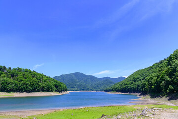 Nukabira River Bridge with Nukabira Lake, River and Dam under July Blue Sky, Hokkaido Japan


