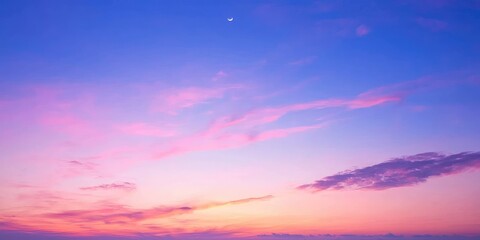 Vibrant pastel sky at dawn with moon fading as sun rises Stock photo