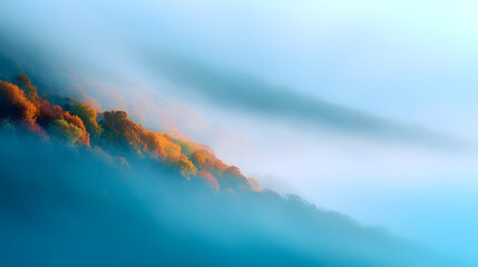 Fototapeta premium A dreamlike landscape where golden autumn leaves merge with tranquil blue mist.