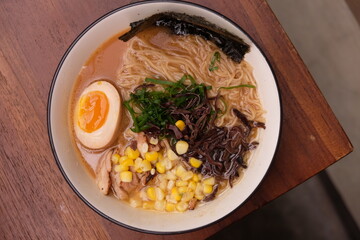Tonkotsu ramen, Japanese noodle soup with soft boiled egg, scallion, sweet corn, nori, cha shu....