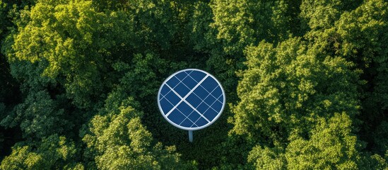 Overhead view of a circular structure, nestled amidst lush green trees, a symbol of nature and tech