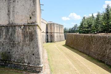 The thick stone walls and bastion of the Forte Spagnolo fortress in L'Aquila, Italy, a historic and imposing piece of Spanish military architecture.