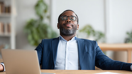 Office worker practicing deep breathing exercises at desk for mindful break from work