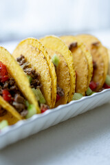 Close-up of Mexican-style tacos with ground meat and vegetables