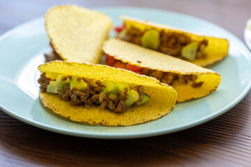 Close-up of Mexican-style tacos with ground meat and vegetables