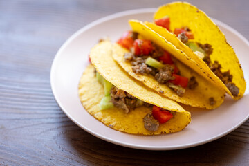 Close-up of Mexican-style tacos with ground meat and vegetables