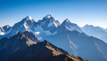 Panoramic view of snow-capped mountain range under a clear blue sky