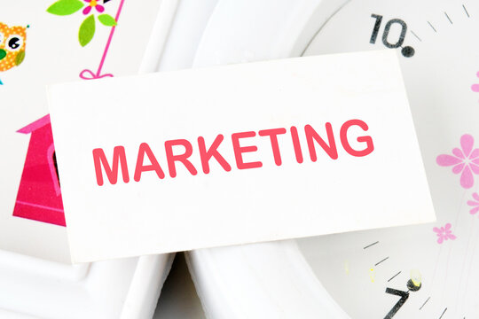 Marketing,concept TEXT text on the business card on the background of the clock