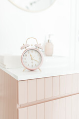 Pastel Pink Alarm Clock in Minimalist Bathroom