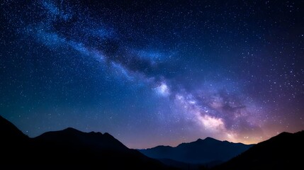 Naklejka premium A starry night sky over silhouetted mountains.