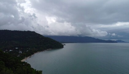 Fototapeta premium Panoramic view of a coastal landscape under a dramatic overcast sky.