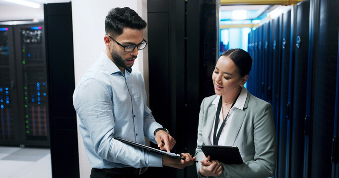 Man, woman and clipboard in server room for discussion, team or checklist for IT solution at company. People, cybersecurity and point with review, maintenance or information technology at data center