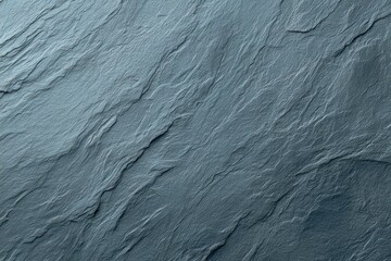 Fototapeta premium Detailed slate rock texture, showing layers and diagonal lines in shades of gray and blue