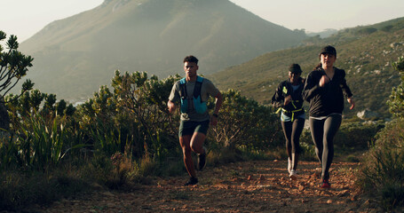Active, fitness and group running on mountain trail for marathon practice, endurance and exercise. Cardio club, people and jogging in nature for pace training, sports performance or workout challenge