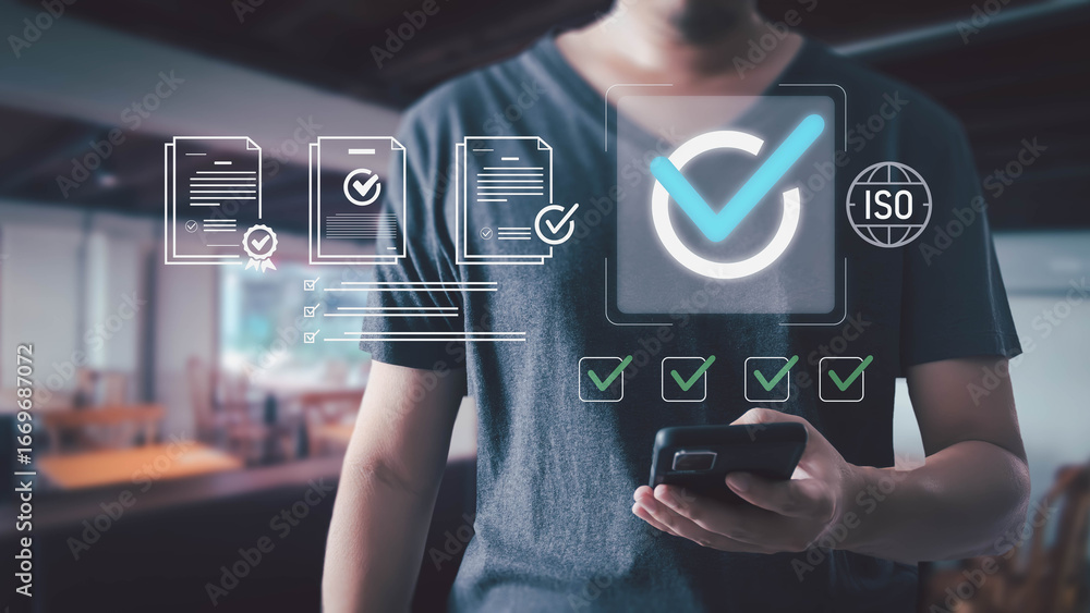 Aufkleber man holding smartphone with virtual interface showing iso certification and quality assurance docume